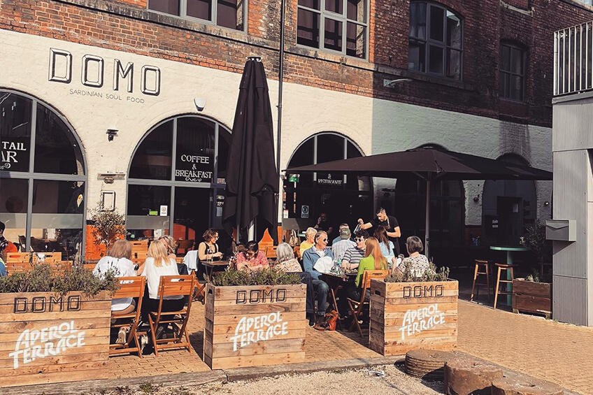 People eating outside Domo in Kelham Island. Recommended by Treasure Hunt Sheffield.