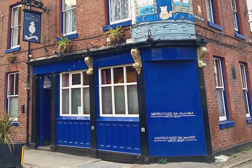 The colourful outside of the Fat Cat pub with flood markings in Kelham Island. Recommended by Treasure Hunt Sheffield.