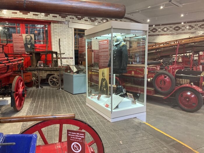 Some fire engines and a fireman's uniform on display at the National Emergency Services Museum